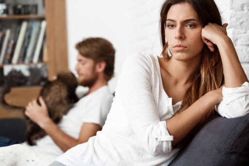 Dissapointed young beautiful brunette girl in quarrel with her boyfriend on sofa background.
Расставание