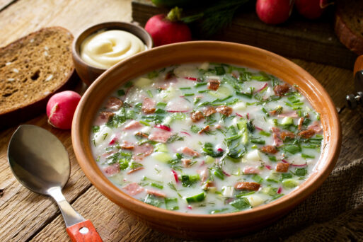 Delicious summer lunch. Spring-summer yoghurt cold soup  fresh vegetables and kefir on rustic wooden table.
Окрошка
Окрошки