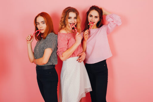 three young and stylish girls in a studio with sweet canty
девушки